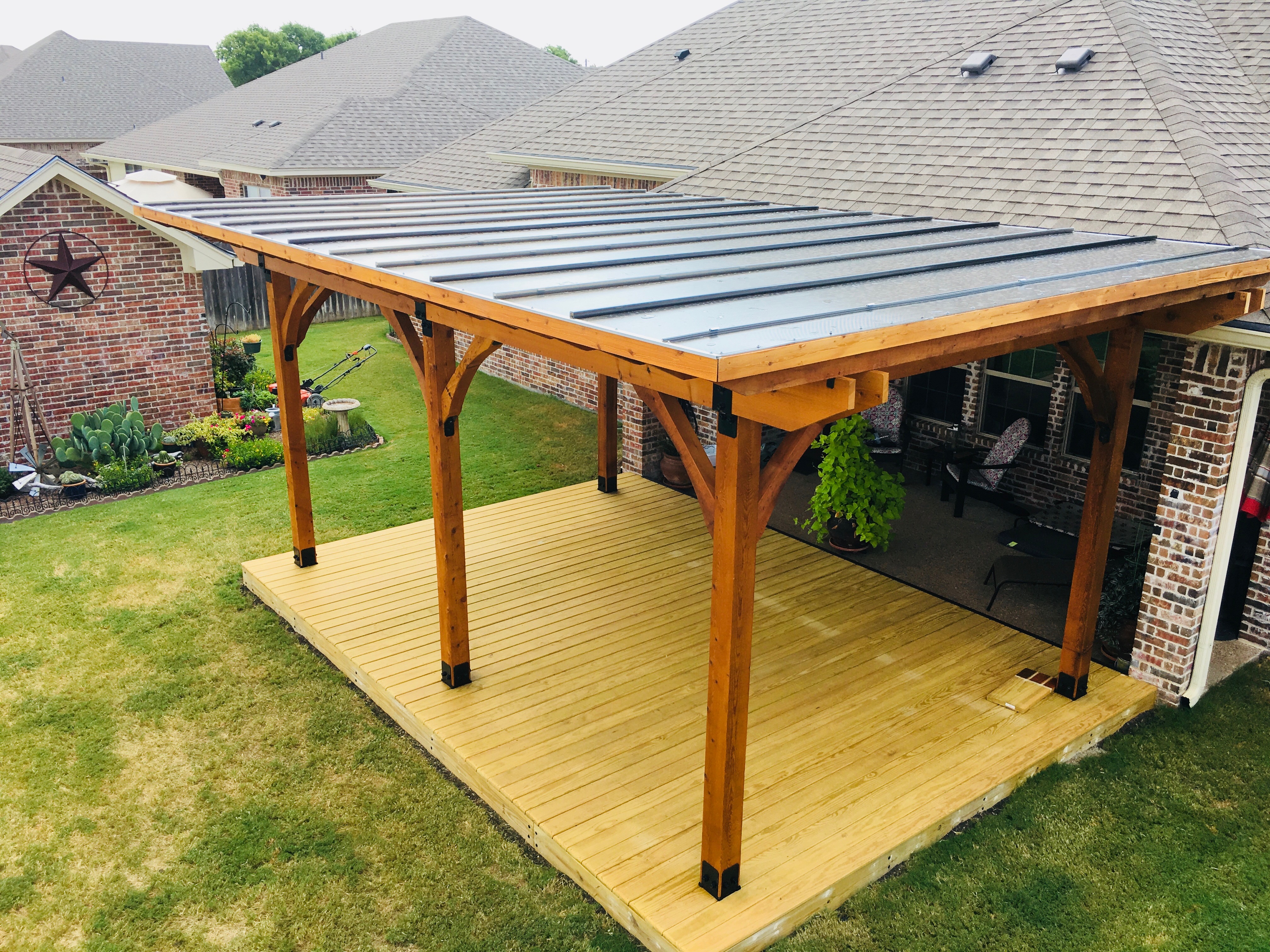 cusom pergola with metal roof and deck